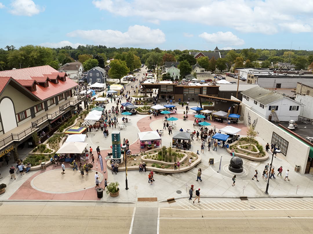 Aerial view of the full plaza with vendor tents and Wizard Quest building