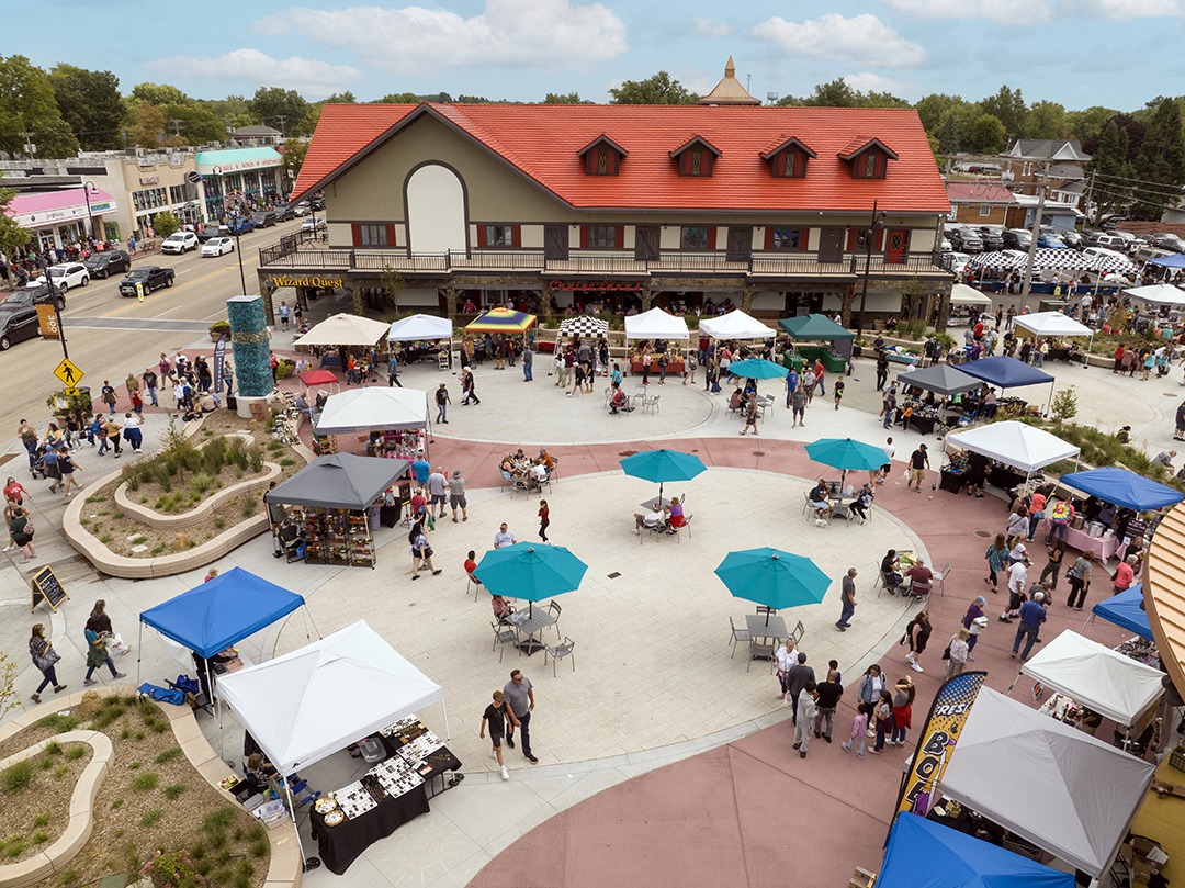 Aerial view of the full plaza with vendor tents and Wizard Quest building