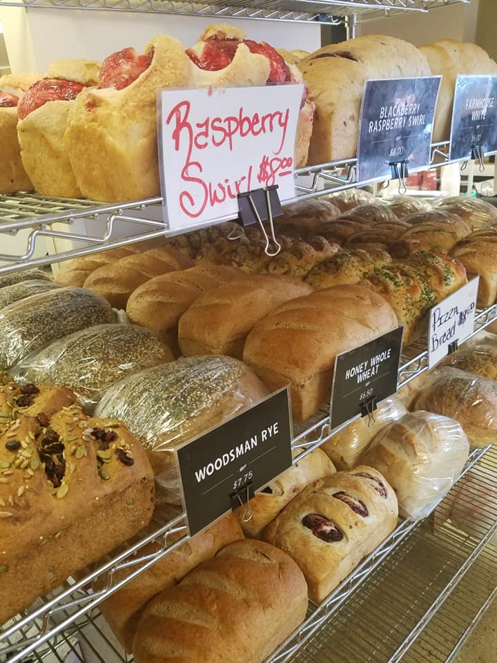 Artisan bread display with Raspberry Swirl and Woodsman Rye loaves