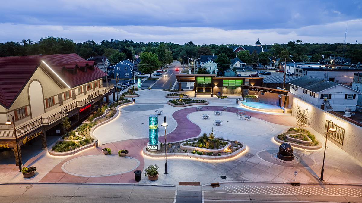Elm Street Plaza at twilight with illuminated pathways and glowing glass pillar